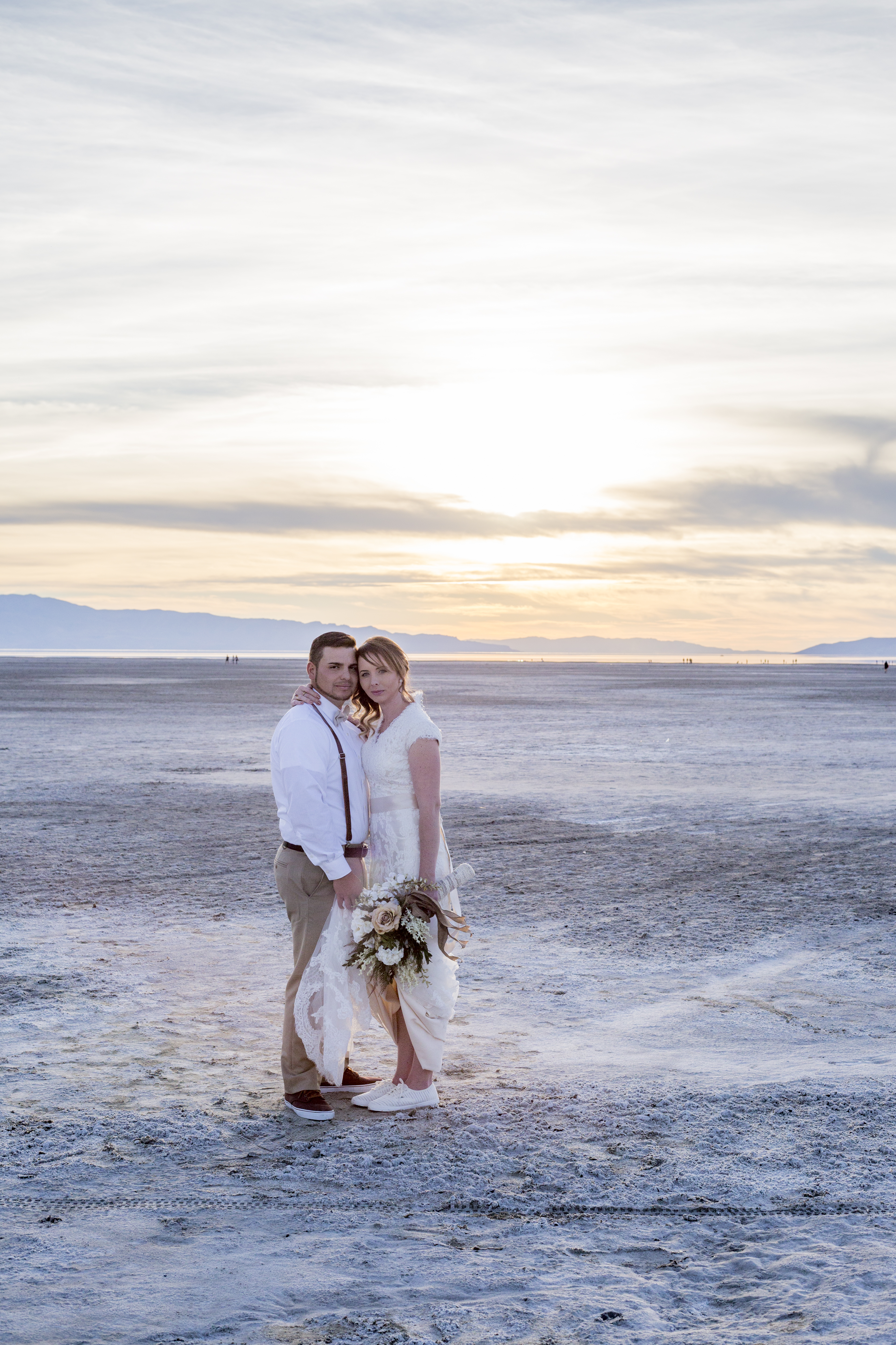 A couple at golden hour during a wedding photoshoot on the Salt Flats in Utah.