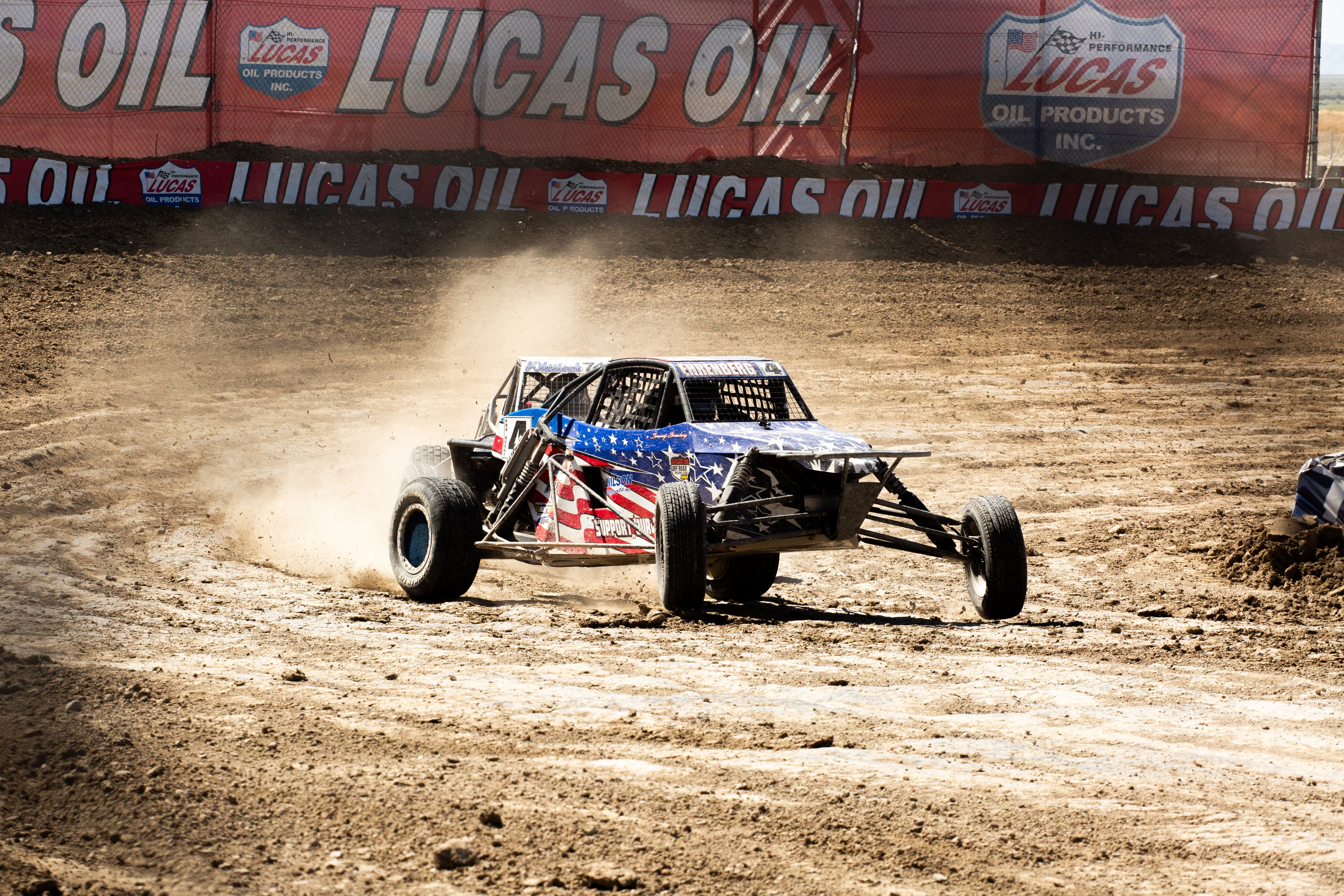 An American flag themed race truck at a motorsports event.