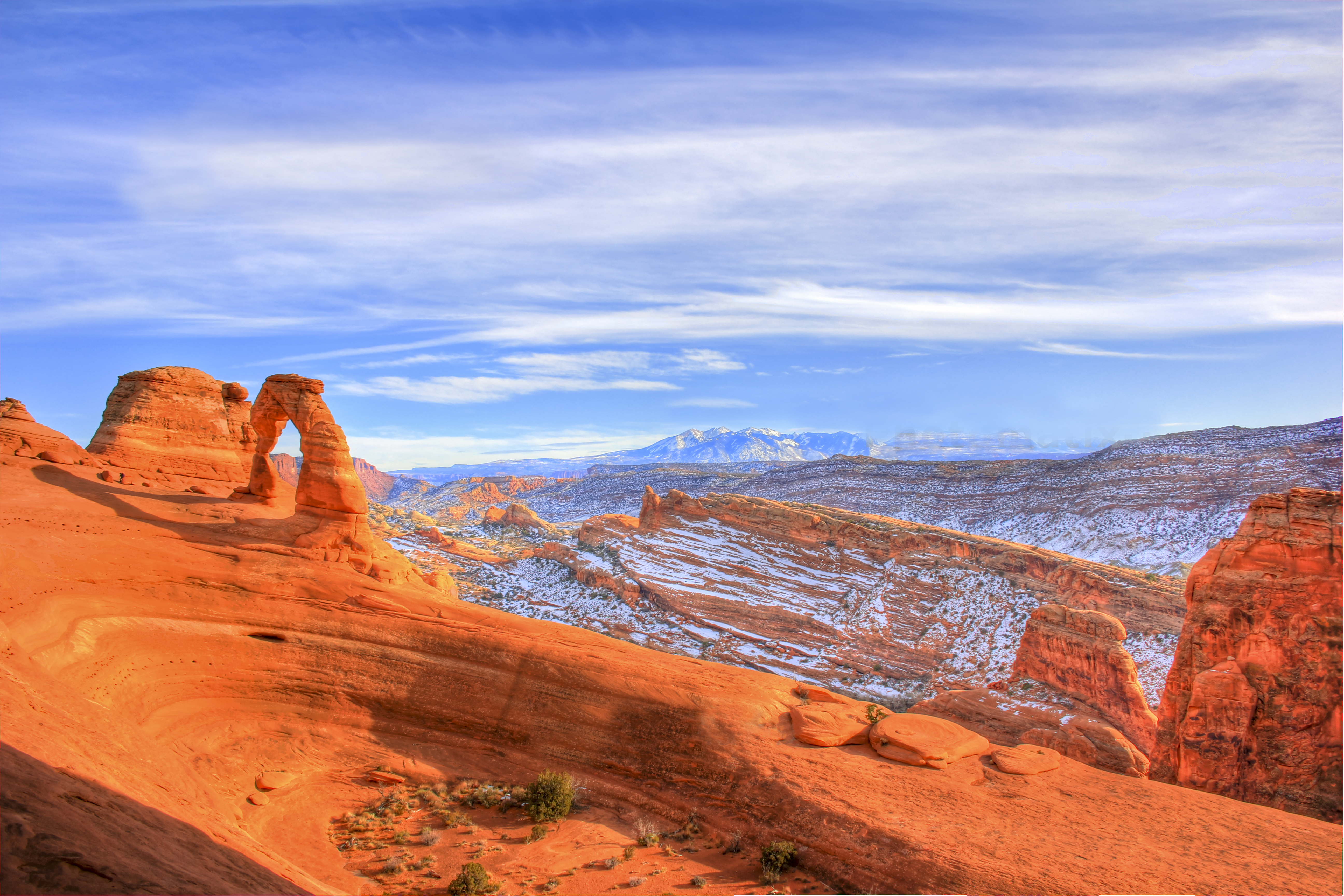 Famous red rock Delicate Arch at Arches National Park in Utah under a blue sky.