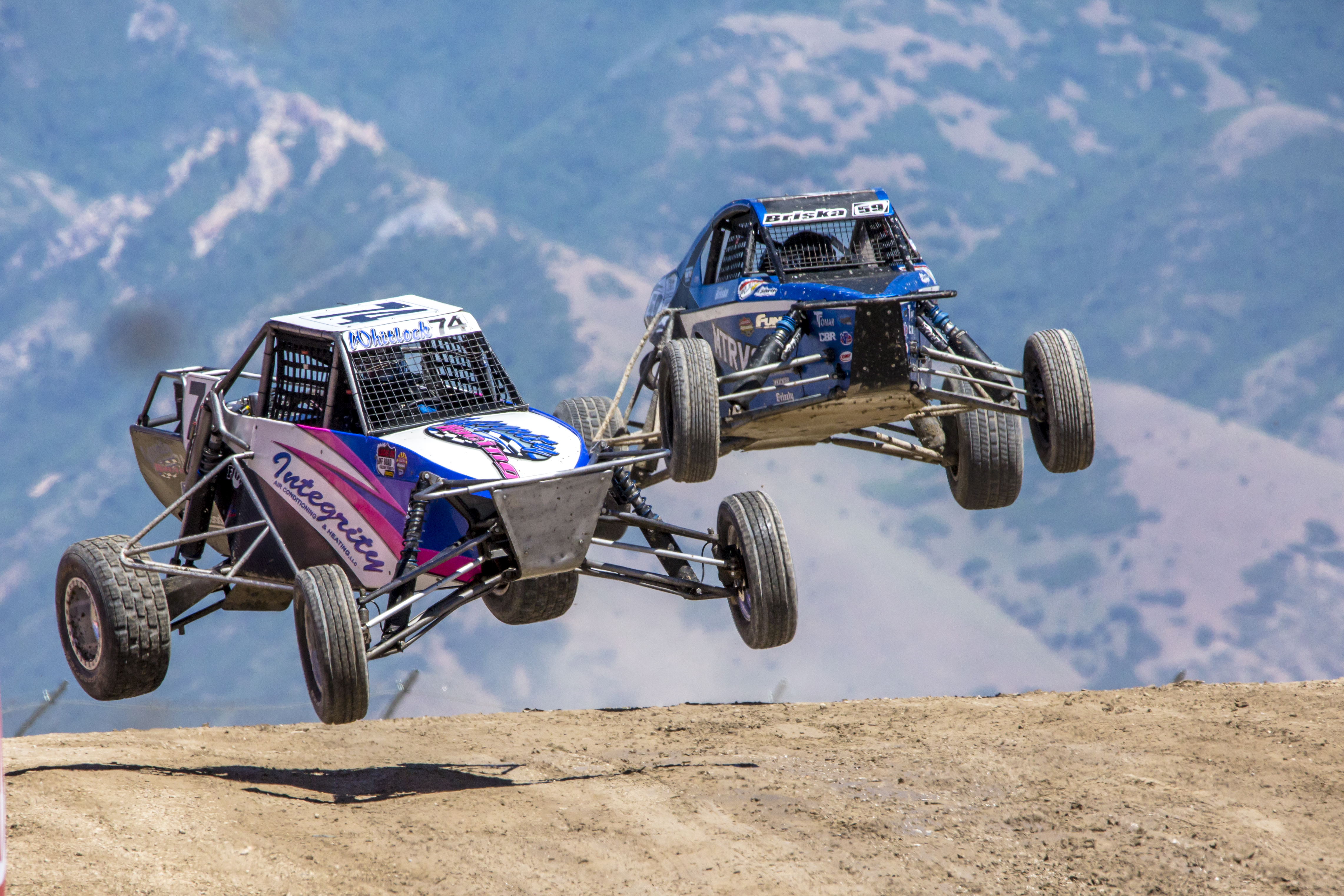 A race buggy driving through the desert during a competition.