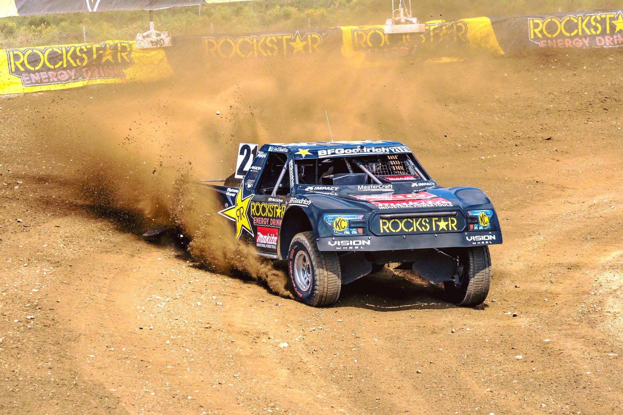 A Pro 4 class off-road truck drifting around a corner on a dirt track.