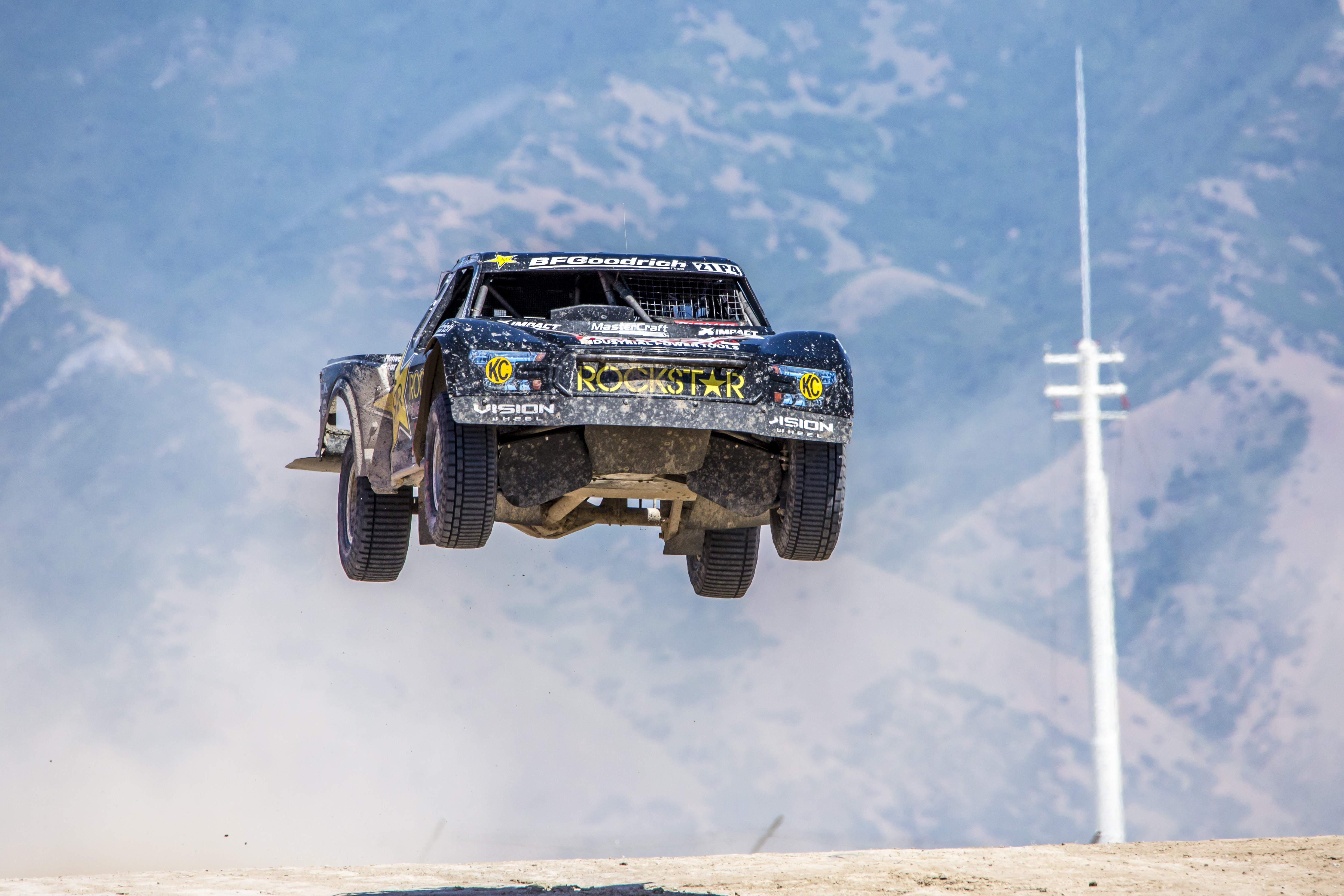 Action shot of a Rockstar energy sponsored truck during an off-road race.